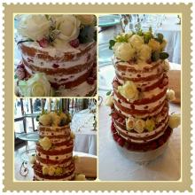 3 tier naked cake. vanilla bean sponge filled with raspberry jam, white chocolate ganache and Chantilly cream. finished off with white roses and fresh berries